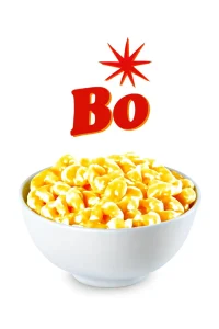 The image features a bowl of creamy macaroni and cheese, with smooth, golden cheese covering the pasta. The bowl is simple and white, and above it, the bold red "Bo" lettering with a starburst graphic adds a vibrant touch. The background is pure white, emphasizing the richness and creamy texture of the dish. Bojangles menu