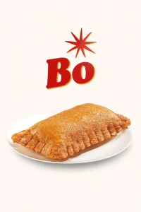 "A Sweet Potato Pie Biscuit featuring a warm, soft biscuit . The biscuit is placed on a white plate with the word 'Bo' in bold red letters and a starburst above it, set against a plain light-colored background. Bojangles Menu